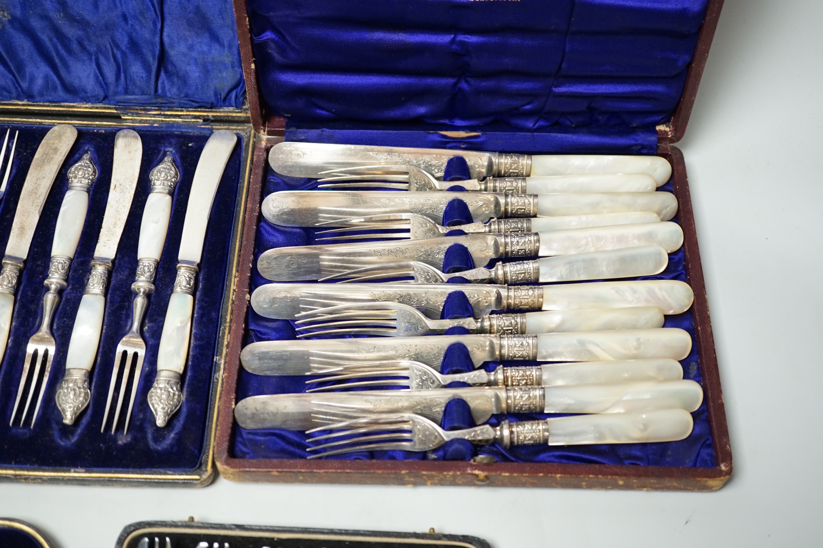 Two cased sets of silver flatware including teaspoons and pair of small servers and two cased sets of plated flatware.